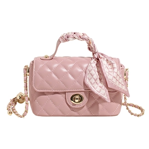 Pink quilted crossbody bag with gold lock and decorative silk scarf handle wrap