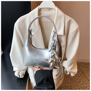 Silver crescent moon shoulder bag with metallic texture and large star charm detail