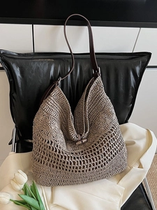 Large woven tote bag with brown leather straps and wooden horn buckle closure