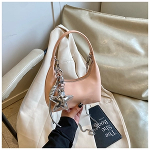 Peach pink glossy leather underarm bag featuring a silver star charm and chain detail