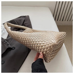 Close-up of champagne gold woven hobo bag showing the intricate intrecciato leather texture