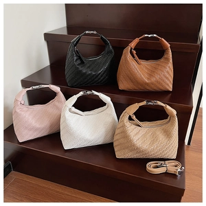Detail of woven texture dumplings bags in five colors with adjustable shoulder straps