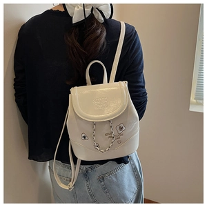 Detail of white chain backpack showing heart embroidery and love freedom life text