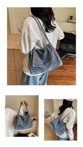 Detail of blue denim tote bag with metallic chain strap and front metal bar accent
