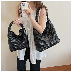 Detail of black woven leather bucket bags showing intricate texture and two-piece sizes