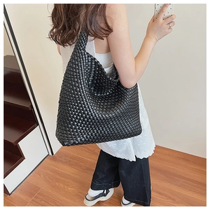 Close-up of premium black woven hobo tote bag featuring large capacity and sleek texture