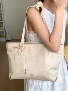 Beige soft leather tote bag with knot strap and small card pouch for daily commute