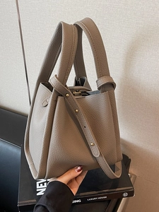Lychee grain leather bucket bag in taupe with double handles and slim shoulder strap