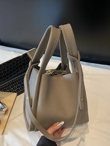 Dark grey pebble leather bucket bag with top handle and gold-tone hardware for women