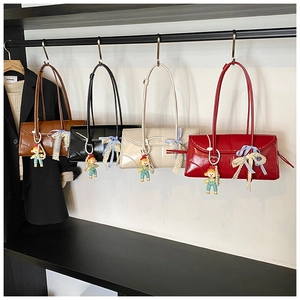 Close-up of stylish large tote bags in four colors with cute charms and lace bows