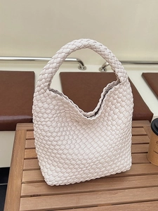 Chic cream woven bucket handbag with wide single handle for elegant women commuting