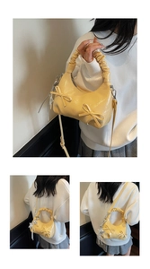Close-up of cream bow shoulder bag with ruffled handle and silver star pendant detail