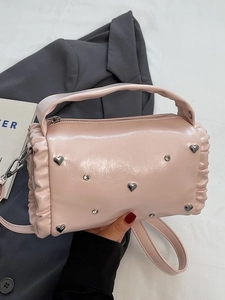 Pink pleated barrel crossbody bag with heart studs and silver rhinestone accents