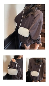 Detailed view of ivory lychee leather camera bag with adjustable shoulder strap