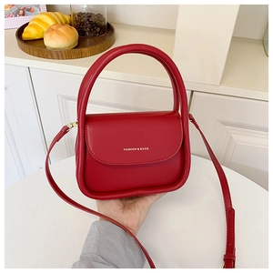Close-up of red PU leather mini crossbody bag with Fashion & Bags print and top handle