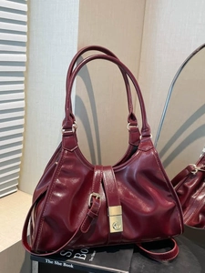 Vintage burgundy minimalist shoulder bag with gold clasp and sleek glossy finish