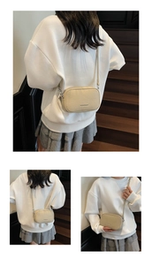 Detail of beige litchi grain leather crossbody bag with adjustable strap and embossed logo