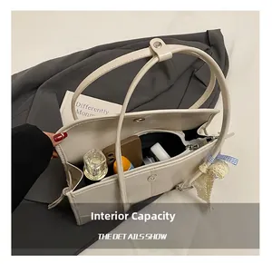 Interior view showing the large storage capacity of this beige tote bag with daily items