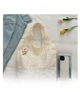 Spacious off-white lace tote bag with floral embroidery and pink plush flower accessory