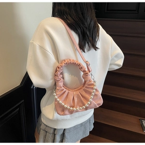 Detailed back view of pink pleated cloud bag with pearl chain and slender strap