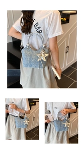 Detailed views of light blue denim bucket bag with silver metal ring and star charm