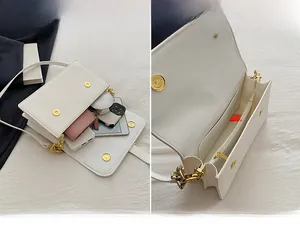 Detailed interior of a white flap bag showing the main compartment and zipper pocket