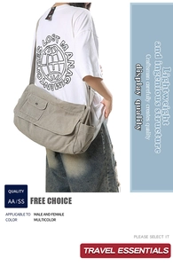 Detail view of large grey canvas messenger bag with adjustable strap and buckle pocket