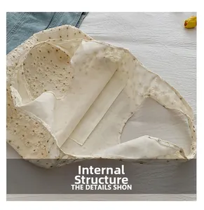 Interior view of the beige lace tote bag featuring a practical internal slit pocket