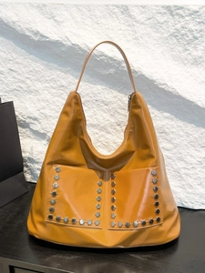 Chic mustard yellow oversized rivet tote bag in glossy finish with silver stud details