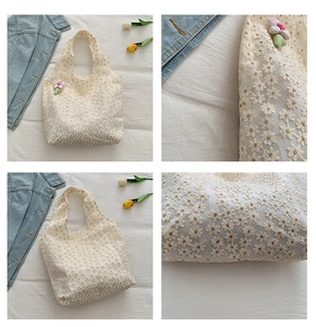 Detail view of lace tote bag with floral embroidery and pink plush flower charm