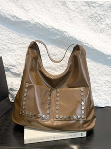 Brown shiny leather tote bag with silver studs and front pockets in vintage style