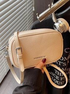 Beige litchi leather square crossbody bag with silver logo and adjustable strap