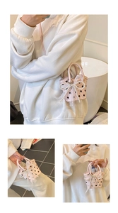 Detail of pink polka dot mini bucket bag with pearl bow and lace charm decoration
