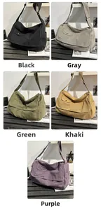 Multiple colors of large canvas crossbody bags with adjustable straps and front pockets