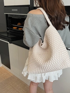 Minimalist beige woven tote bag for women with a spacious design and shoulder strap