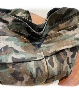 Close-up of jungle camouflage canvas fabric with durable double-stitched seam detail