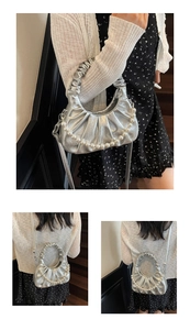 Detail of silver pleated cloud bag with pearl chain and detachable shoulder strap