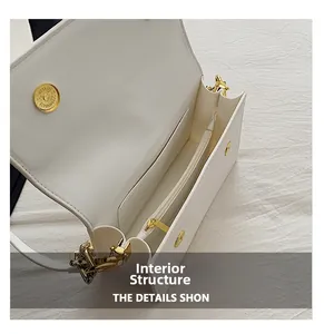 Detailed internal structure of white faux leather crossbody bag with golden magnetic clasp