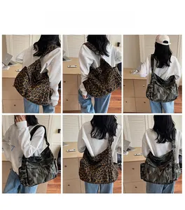 Detail view of large canvas messenger bag with leopard and camo prints on a model