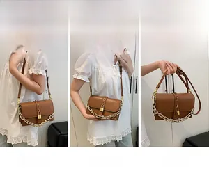 Brown leather crossbody bag with gold chain strap shown in shoulder and handheld styles