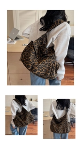 Detail showing the large-capacity leopard print canvas tote bag with wide shoulder strap