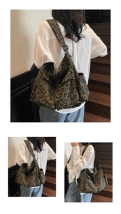 Detail view of large canvas crossbody bag with leopard print and adjustable shoulder strap
