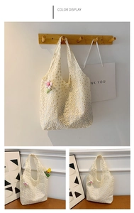 Detailed view of cream lace tote bag with floral embroidery and pink plush flower charm