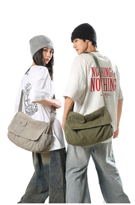Detail of adjustable straps and metal snap pockets on minimalist canvas crossbody bags