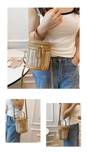 Detail of hand-woven straw bucket bag with premium brown leather handle and zipper closure