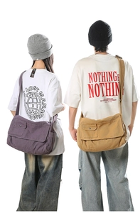 Rear view of purple and khaki canvas messenger bags on male and female models