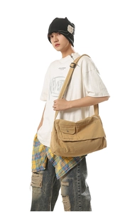 Detailed view of khaki large canvas crossbody bag with metal buckle and adjustable strap