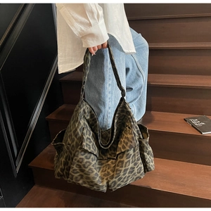 Detail of leopard print tote bag with functional large front pockets and durable fabric