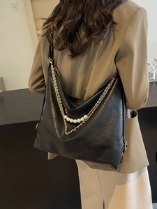 Large black pleated leather tote bag with elegant pearl chain decoration and strap