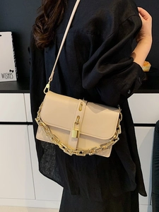 Chic beige messenger bag with chunky gold chain, metal padlock and adjustable strap